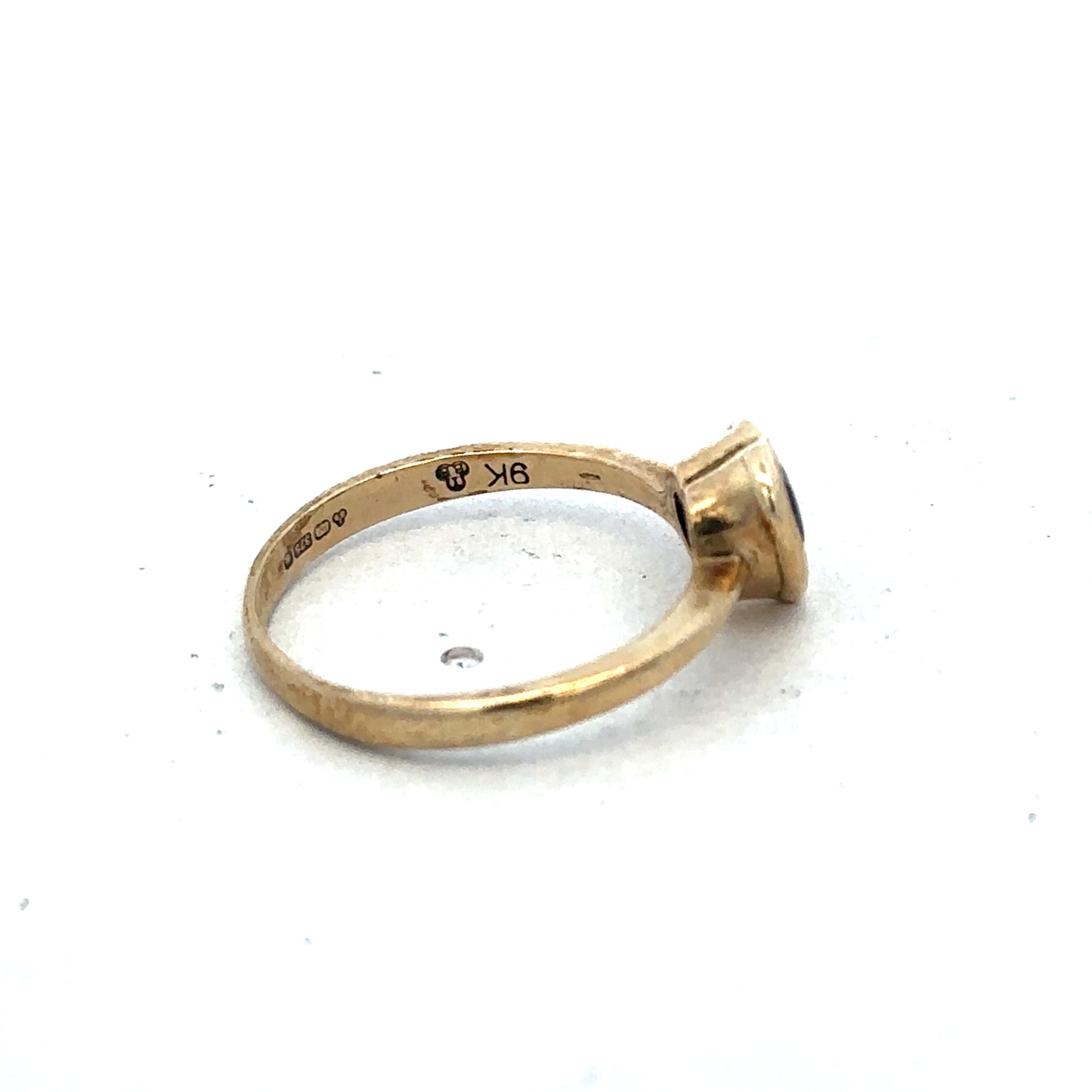 9ct yellow gold ring in size J by Reeves and Sons, showcasing a smooth, polished band with a classic design.