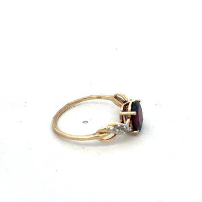 9ct yellow gold garnet and diamond ring, size R1/2, featuring a central garnet stone with diamond accents, by Reeves and Sons.
