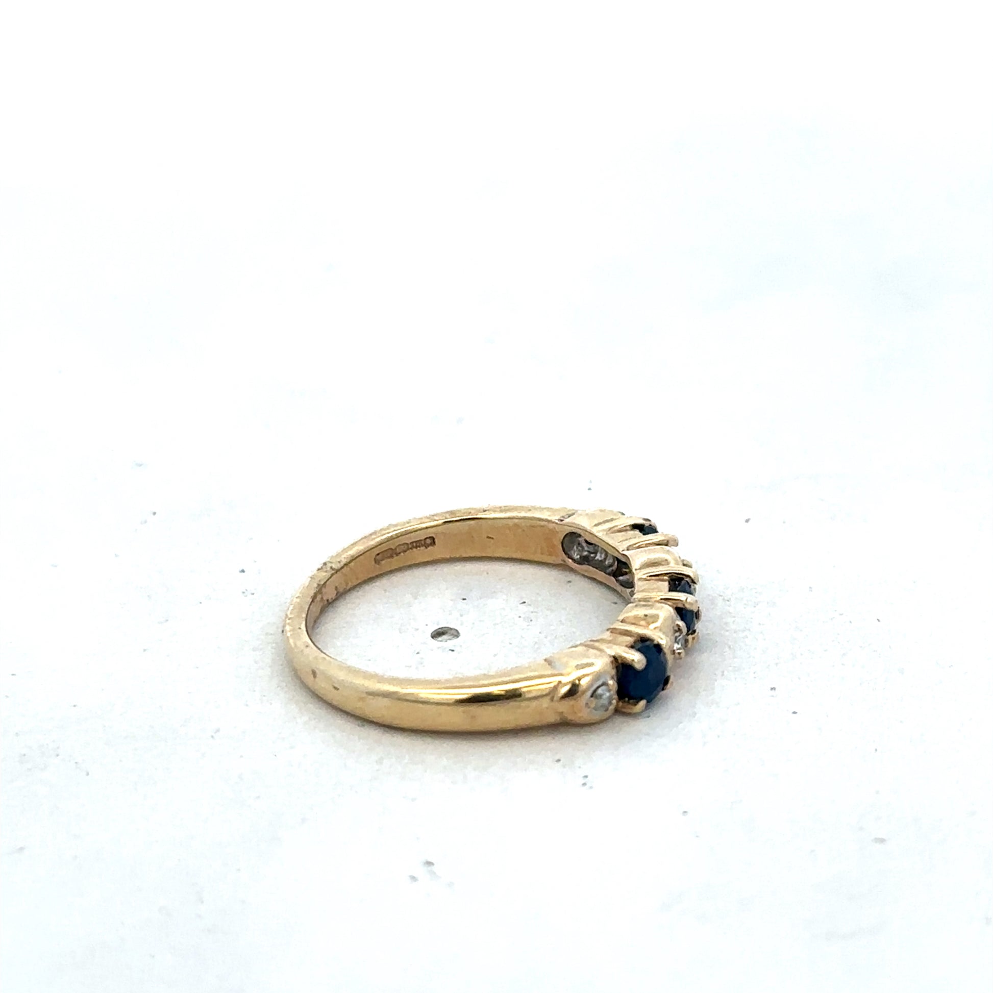 9ct yellow gold sapphire and diamond ring by Reeves and Sons, size M 1/2, featuring a gold band with sapphire and diamond accents.