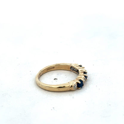 9ct yellow gold sapphire and diamond ring by Reeves and Sons, size M 1/2, featuring a gold band with sapphire and diamond accents.
