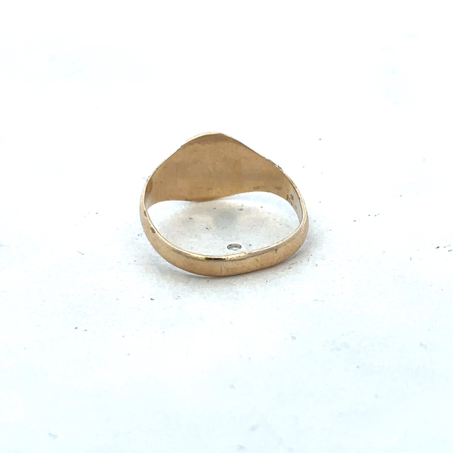 9ct yellow gold signet ring in size M by Reeves and Sons, showing the polished gold surface and classic design.