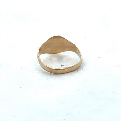 9ct yellow gold signet ring in size M by Reeves and Sons, showing the polished gold surface and classic design.