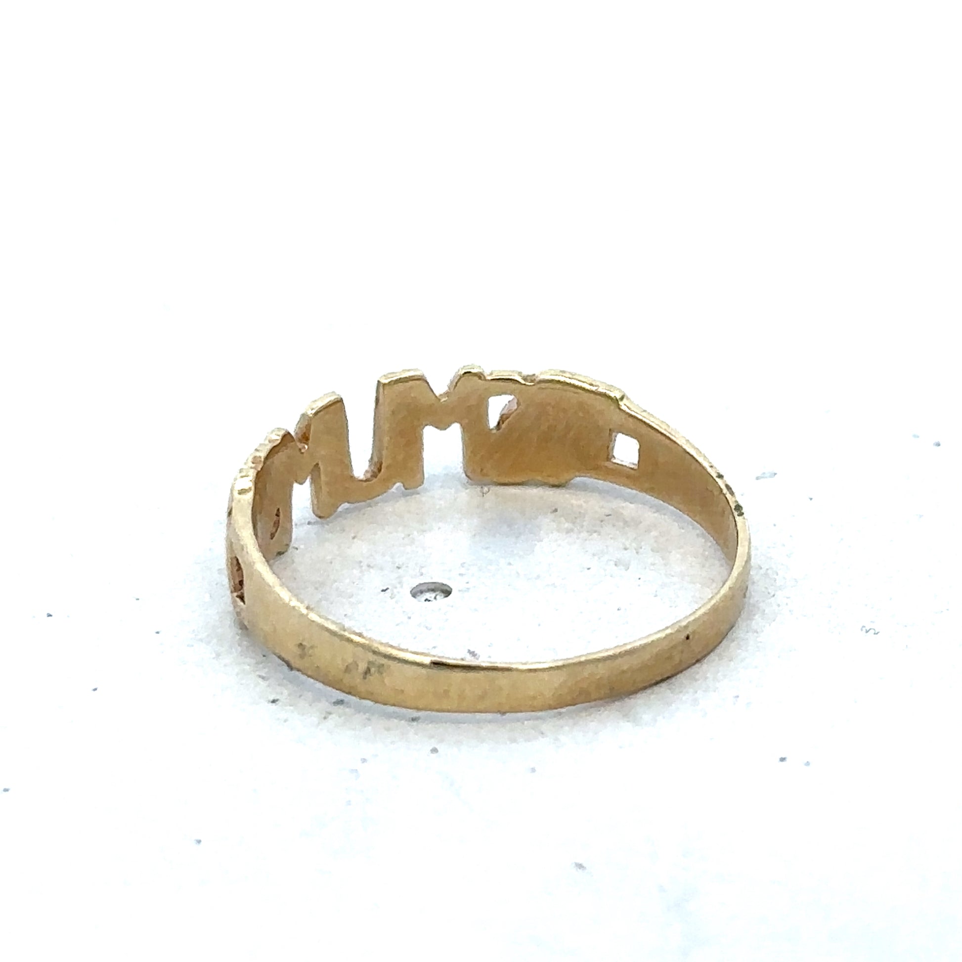 Yellow gold MUM ring in size O from Reeves and Sons, showcasing a polished 9ct gold band with engraved details.
