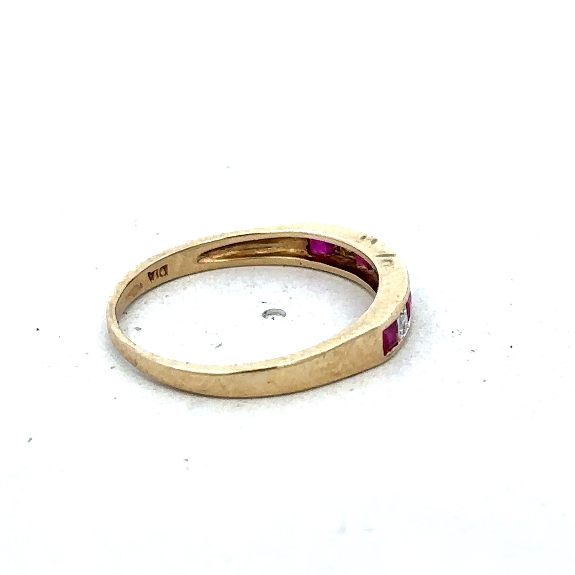 9ct yellow gold ruby and diamond ring in size K1/2, featuring a central ruby surrounded by sparkling diamonds, by Reeves and Sons.
