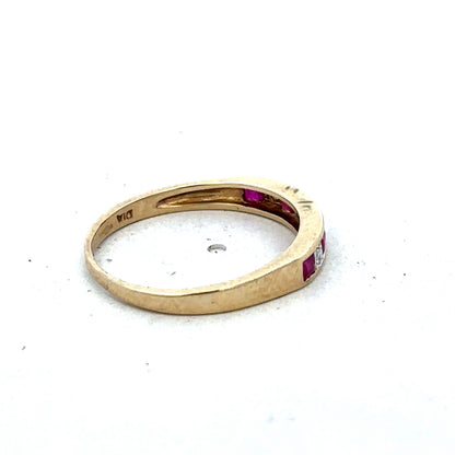 9ct yellow gold ruby and diamond ring in size K1/2, featuring a central ruby surrounded by sparkling diamonds, by Reeves and Sons.