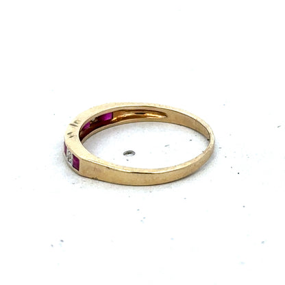 9ct yellow gold ruby and diamond ring, size K½, featuring a central ruby and sparkling diamonds, by Reeves and Sons.