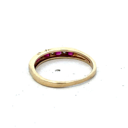 9ct yellow gold ruby and diamond ring, size K1/2, featuring a sparkling gemstone and intricate band design by Reeves and Sons.