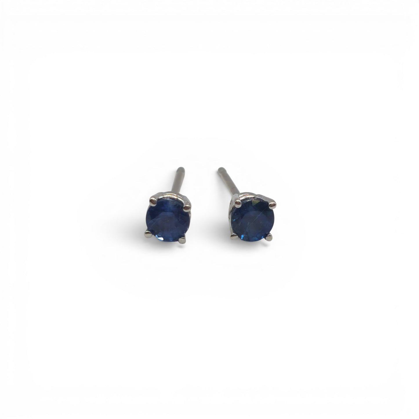 14ct white gold sapphire stud earrings by Reeves and Sons with sparkling blue sapphires and sleek gold settings.