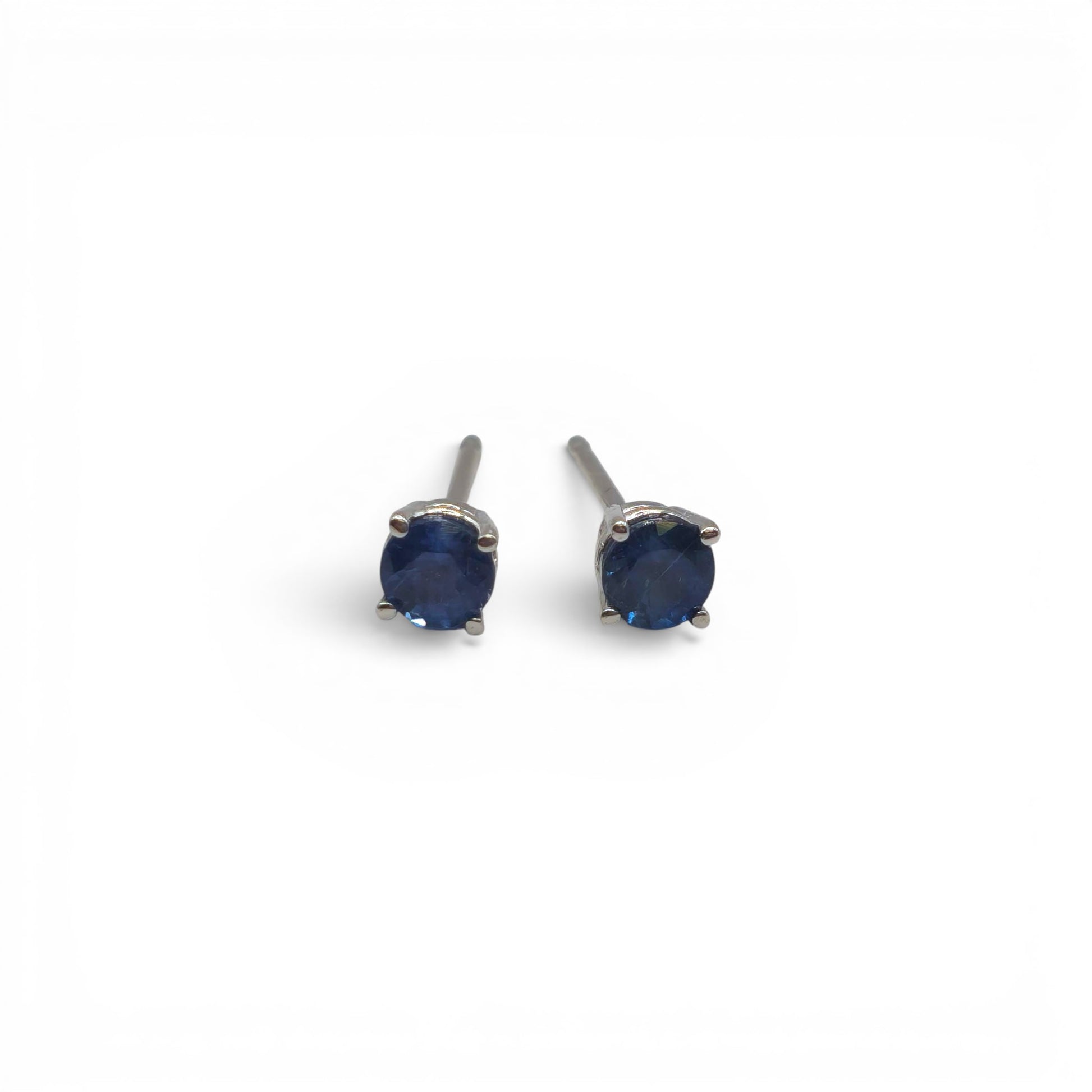 14ct white gold sapphire stud earrings by Reeves and Sons with sparkling blue sapphires and sleek gold settings.