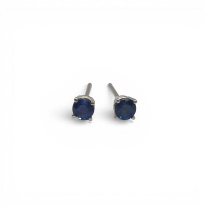 14ct white gold sapphire stud earrings by Reeves and Sons with sparkling blue sapphires and sleek gold settings.