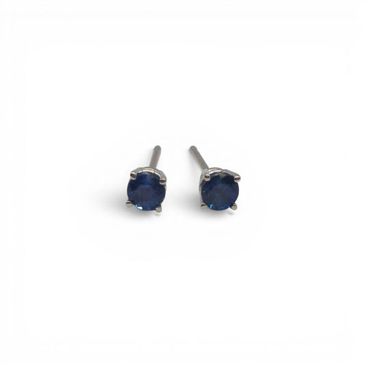 14ct white gold sapphire stud earrings by Reeves and Sons with sparkling blue sapphires and sleek gold settings.