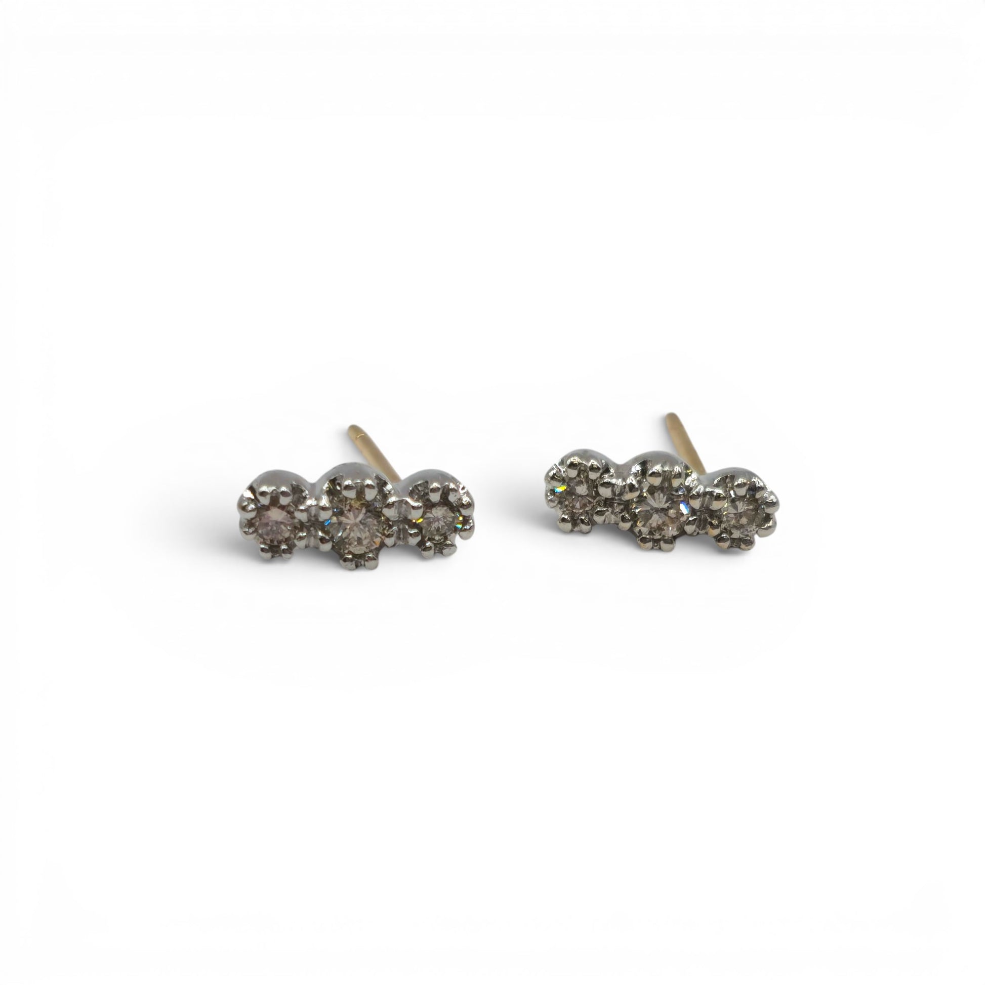 18ct yellow and white gold diamond stud earrings by Reeves and Sons, showcasing sparkling diamonds on a sleek gold setting.