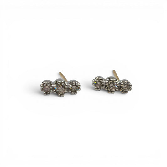18ct yellow and white gold diamond stud earrings by Reeves and Sons, showcasing sparkling diamonds on a sleek gold setting.