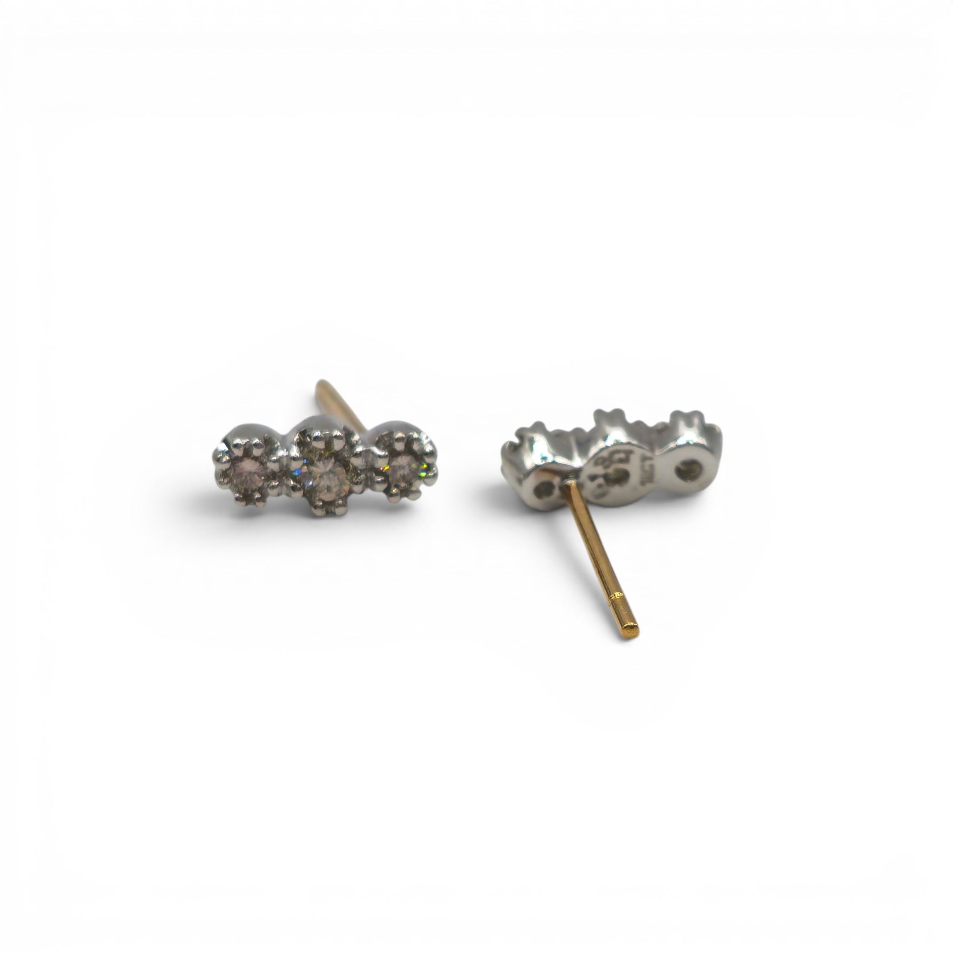 18ct yellow and white gold diamond stud earrings by Reeves and Sons, showcasing sparkling diamonds on a sleek gold setting.