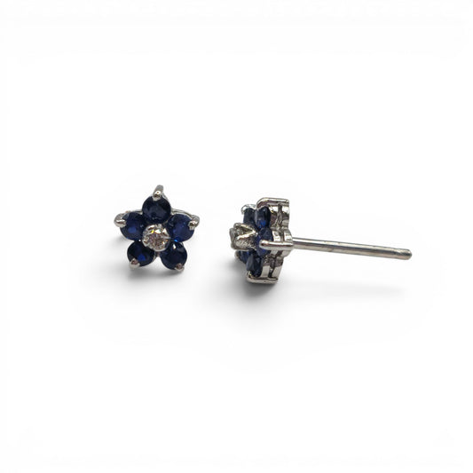18ct white gold daisy sapphire and diamond stud earrings by Reeves and Sons, featuring floral design with sparkling gemstones.