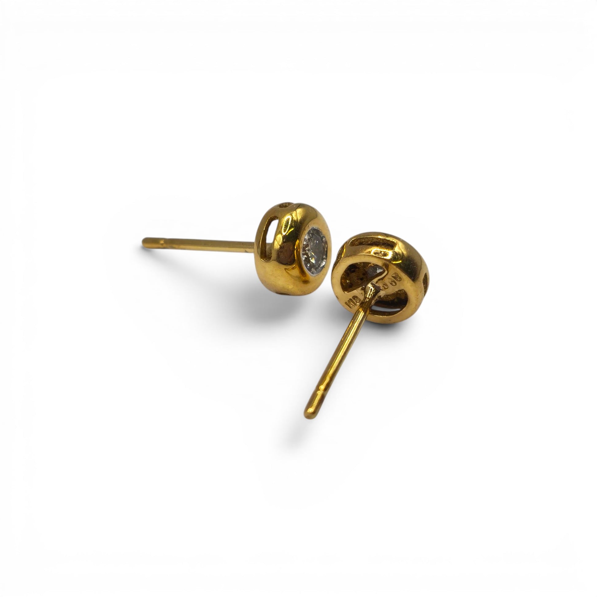 18ct yellow gold diamond stud earrings by Reeves and Sons, showcasing sparkling diamonds set in elegant gold settings.