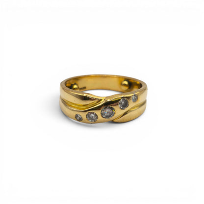 18ct yellow gold diamond crossover ring by Reeves and Sons, featuring sparkling diamonds and a sleek, elegant design.