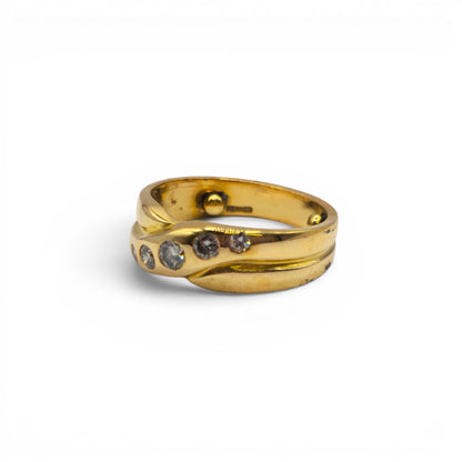 18ct yellow gold diamond crossover ring by Reeves and Sons, featuring sparkling diamonds and sleek design.