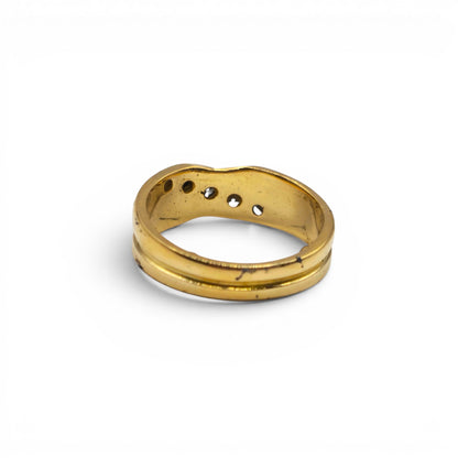 18ct yellow gold diamond crossover ring by Reeves and Sons, showcasing a stylish design with sparkling diamonds on a sleek band.