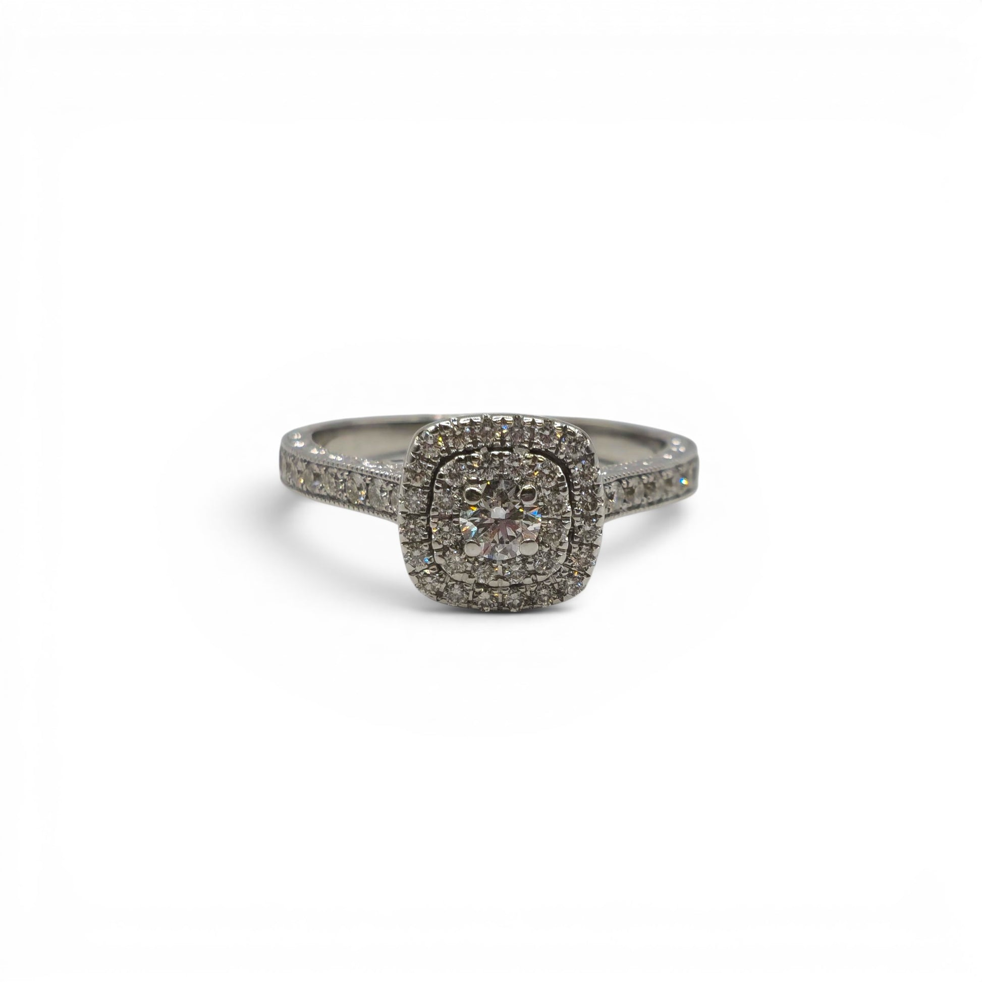 14ct white gold diamond cluster ring by Reeves and Sons with sparkling diamond details and intricate band design.