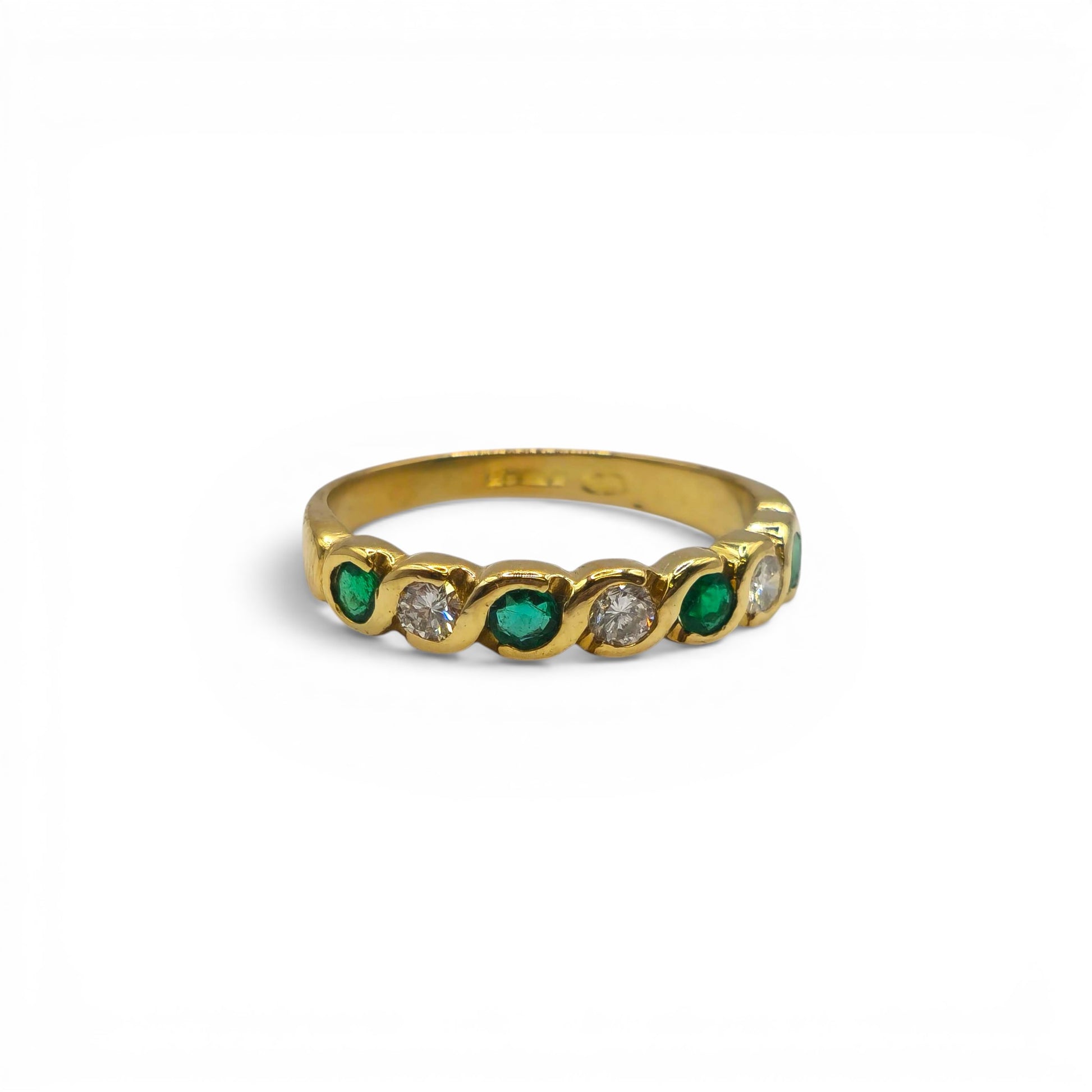 18ct yellow gold half eternity ring with emeralds and diamonds, featuring intricate gemstone settings and Reeves and Sons craftsmanship.