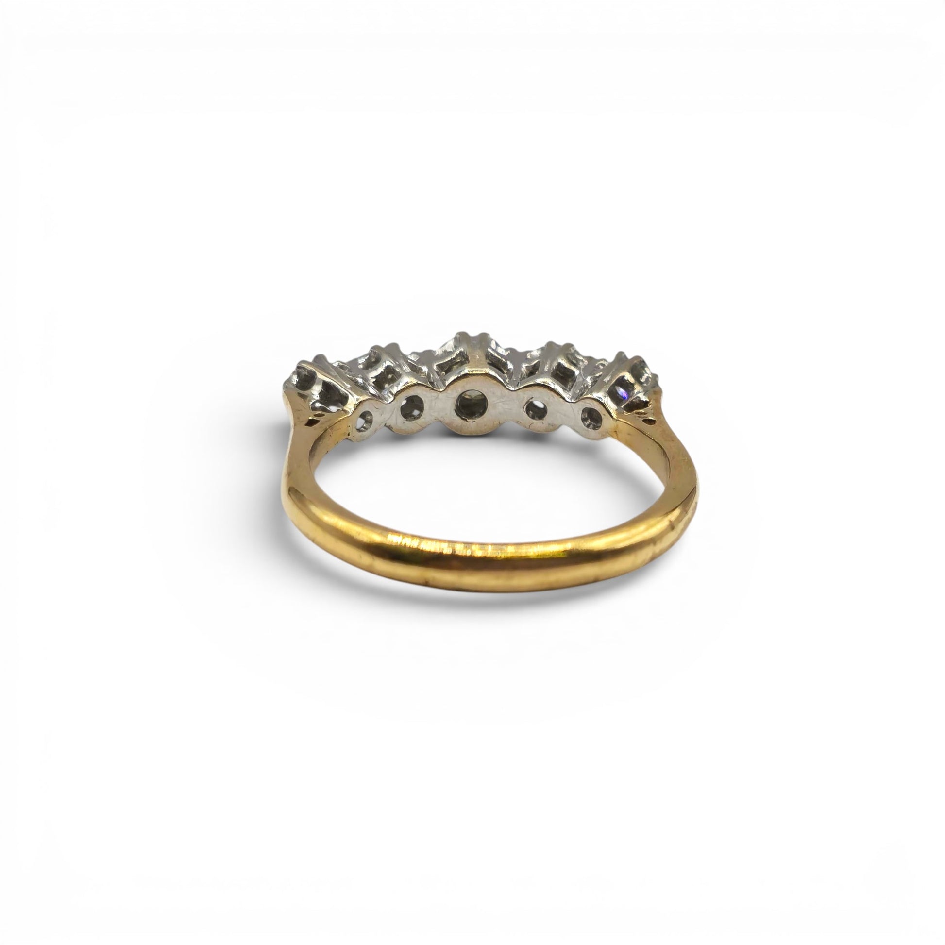 18ct yellow gold diamond ring by Reeves and Sons featuring a sparkling diamond centerpiece and elegant design.