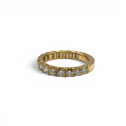 18ct yellow gold diamond eternity ring by Reeves and Sons, showcasing a continuous row of sparkling diamonds on a sleek band.