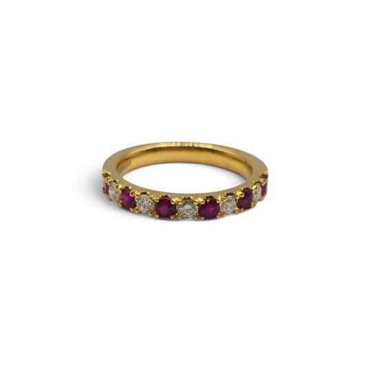 18ct yellow gold ruby and diamond eternity ring by Reeves and Sons, featuring vibrant rubies and sparkling diamonds.
