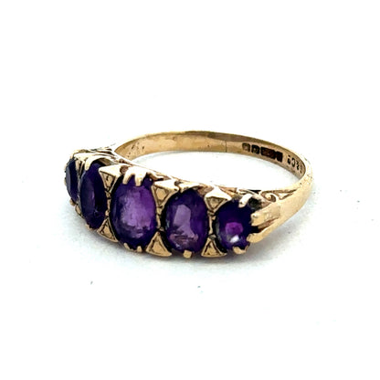 9ct yellow gold amethyst ring in size N with a polished gemstone and intricate band design by Reeves and Sons.