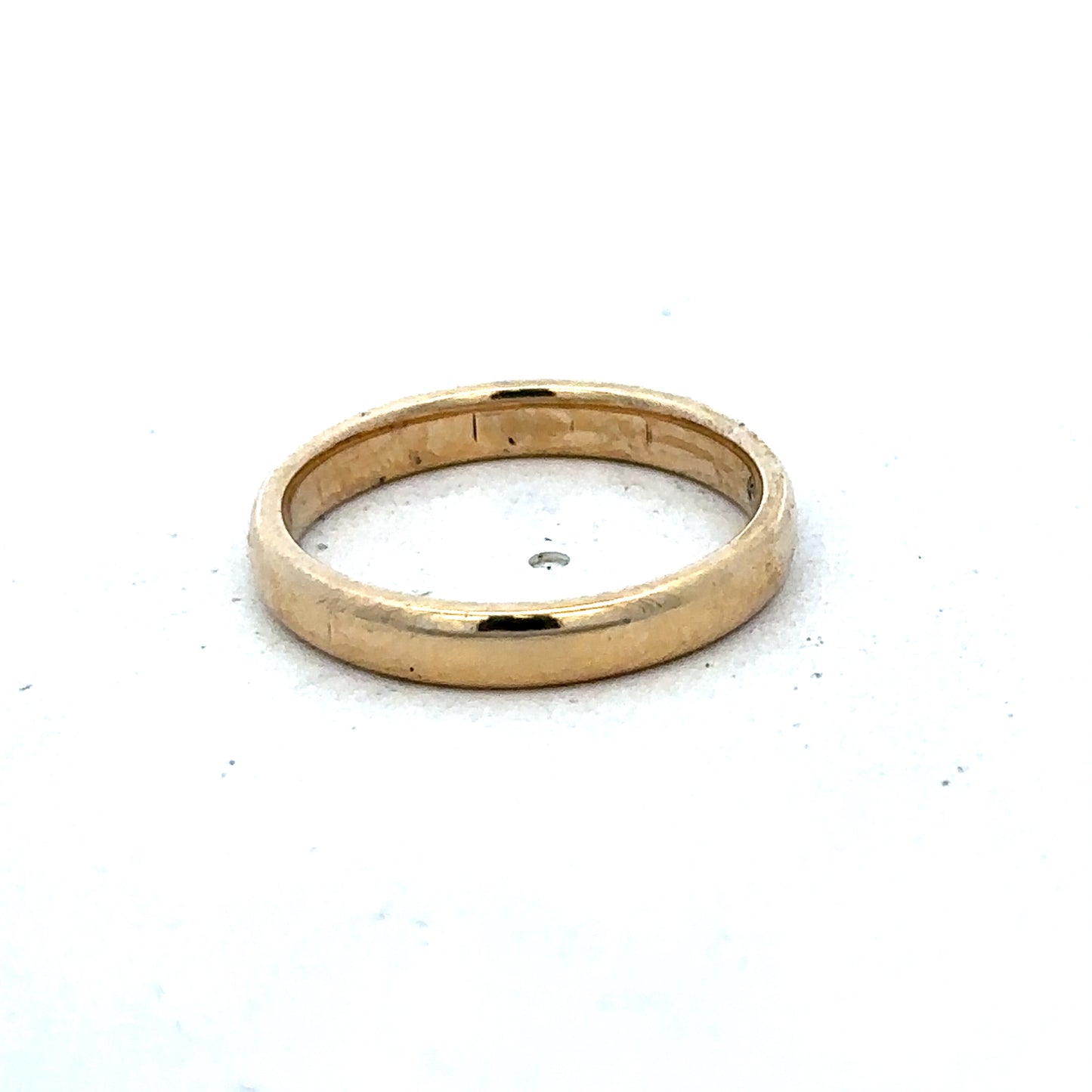 9ct yellow gold ring in size N by Reeves and Sons, showcasing a smooth polished band with subtle detailing.