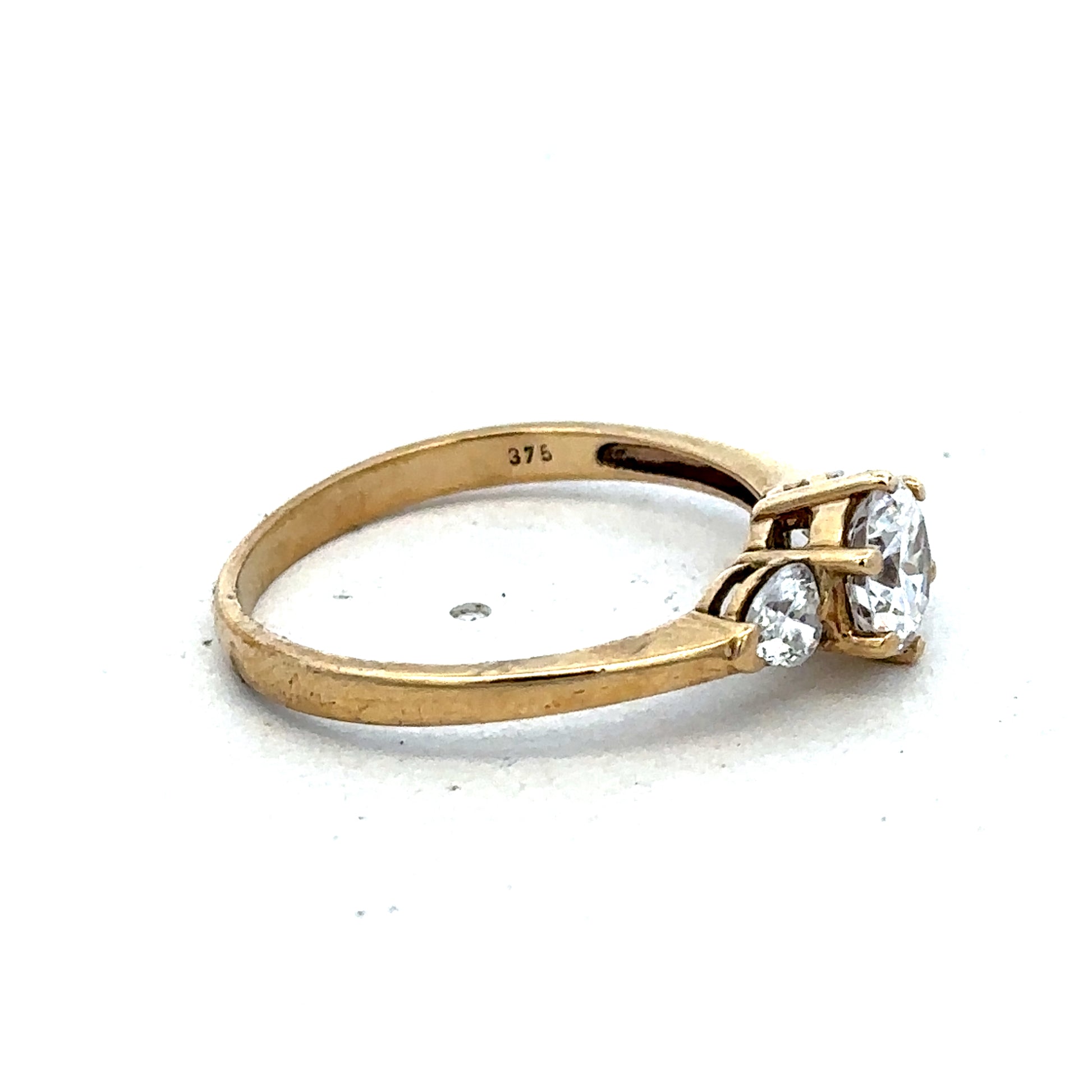 9ct yellow gold CZ ring in size U with intricate band design, crafted by Reeves and Sons.