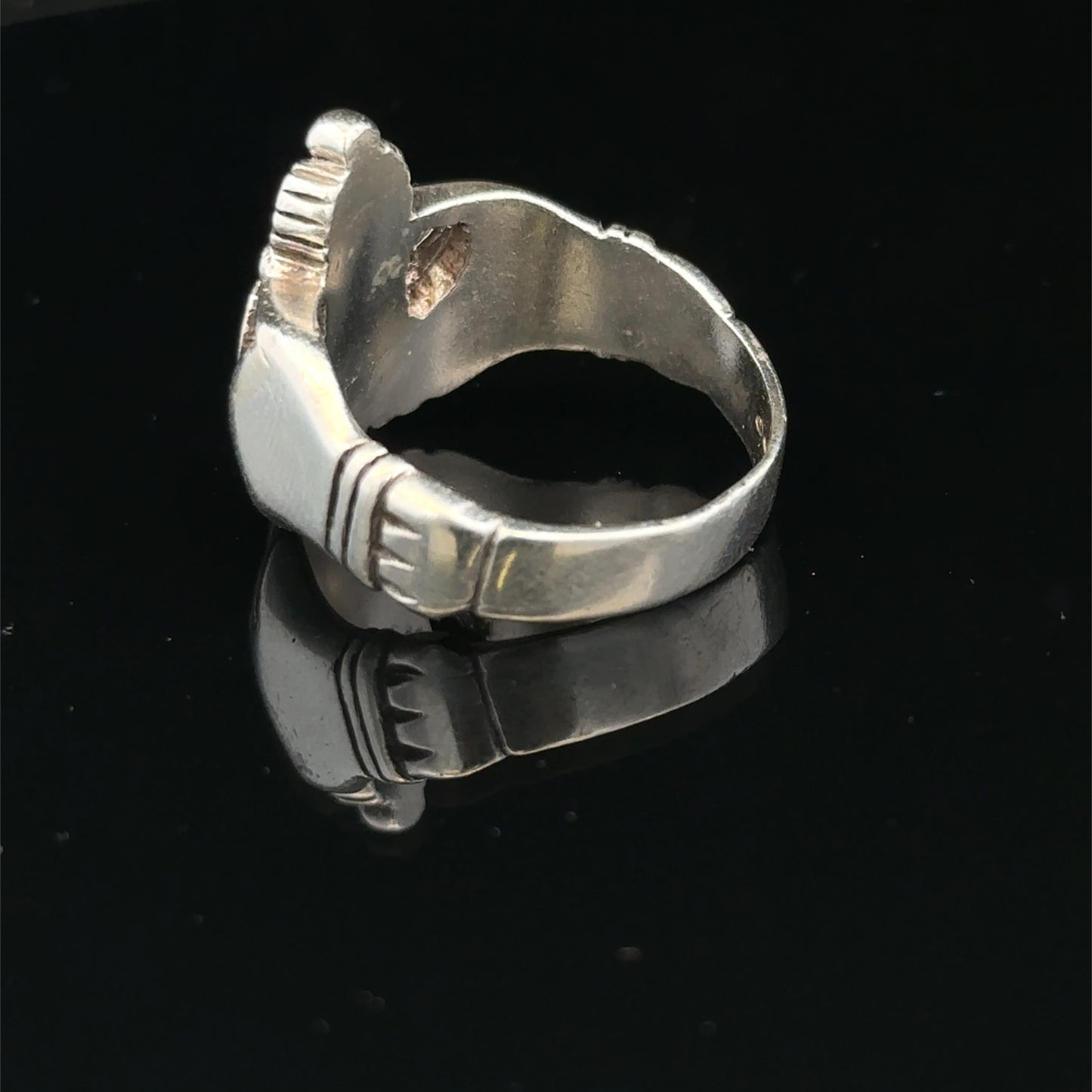Silver Claddagh ring size Z1 by Reeves and Sons, featuring a detailed heart and hands design, displayed on a white background.