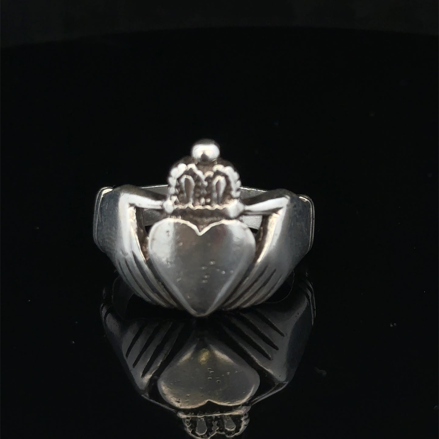 Silver Claddagh ring in size Z1 by Reeves and Sons, featuring traditional heart and crown design, displayed against a neutral background.