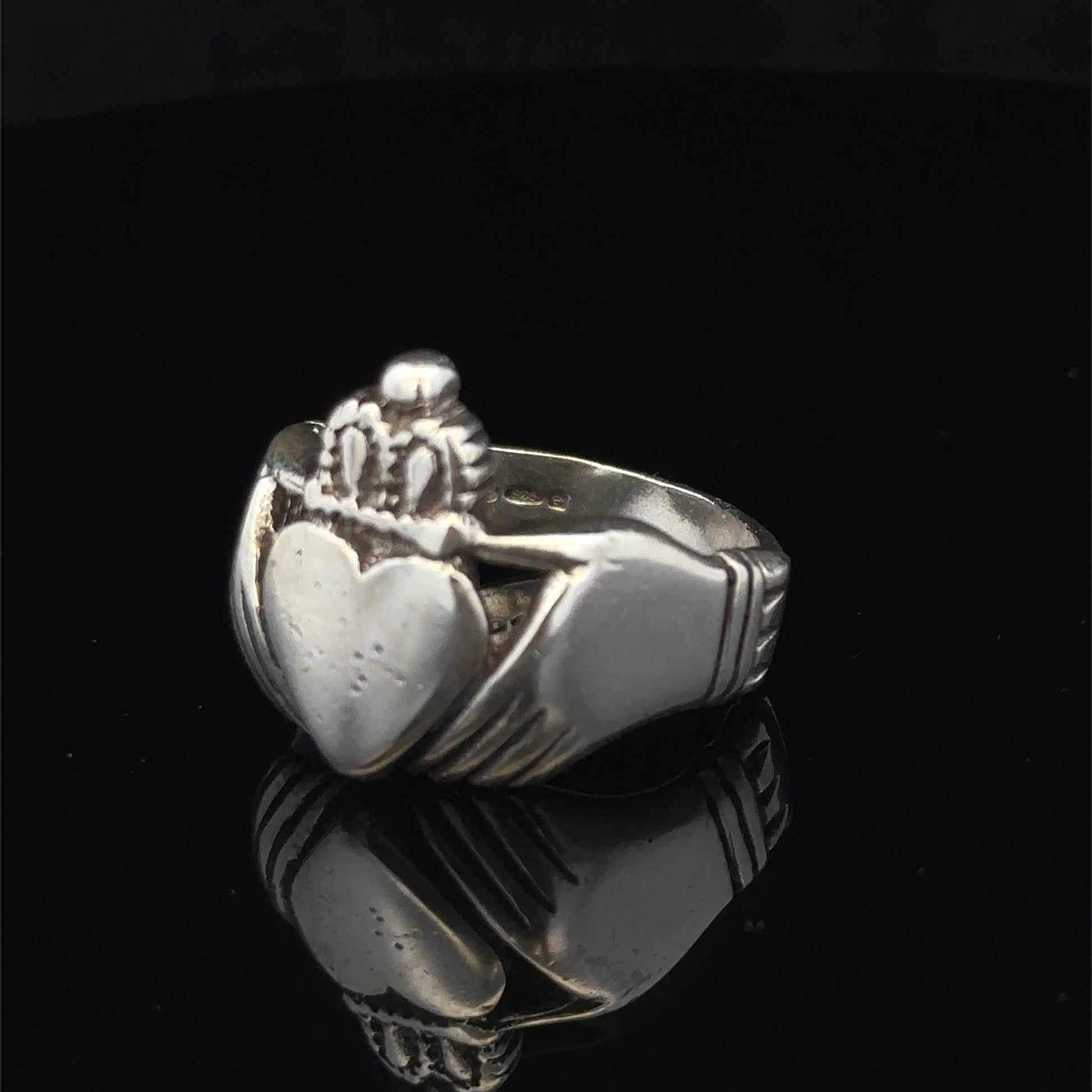 Silver Claddagh ring in size Z1 by Reeves and Sons, featuring traditional Irish design with detailed craftsmanship.