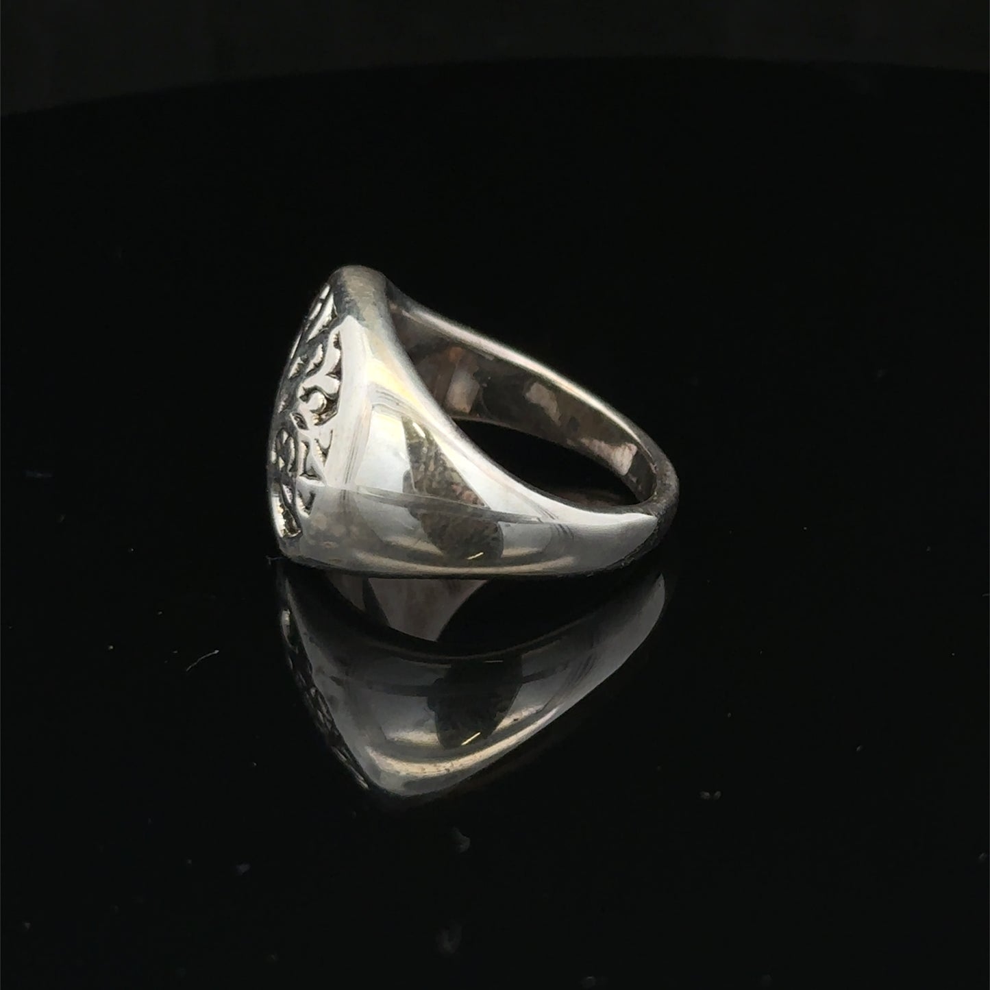 Silver ring size P by Reeves and Sons showcasing a polished band with a smooth, shiny finish.