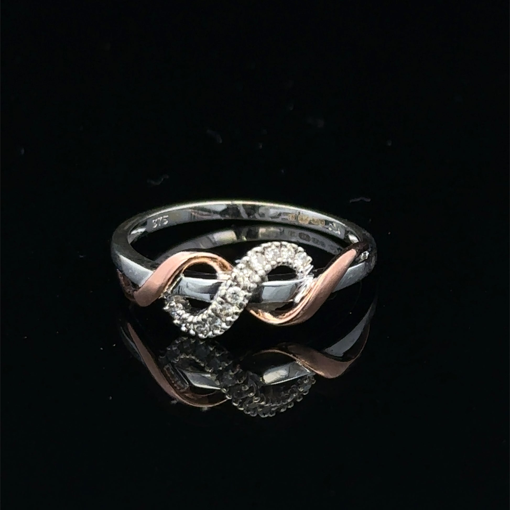 9ct white gold diamond ring in size M with sparkling diamonds, featuring a sleek design from Reeves and Sons.