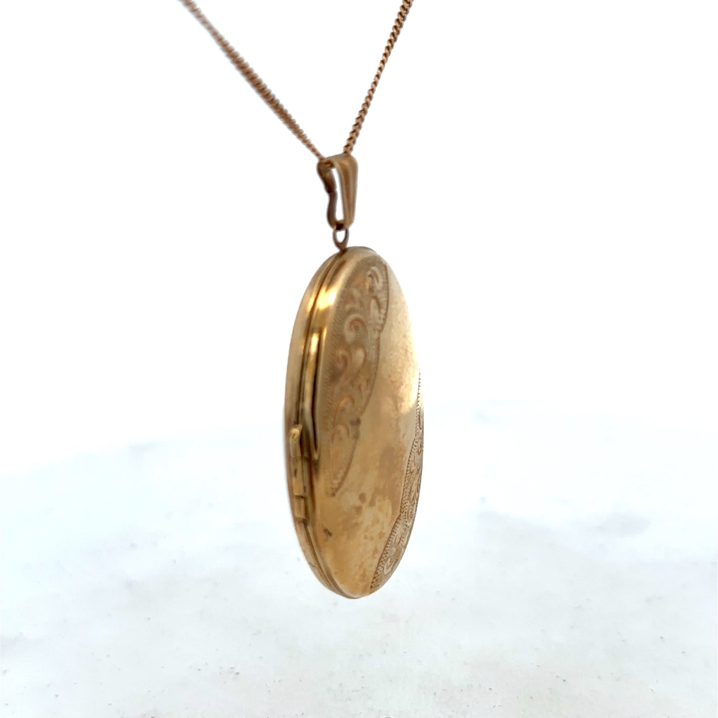 9ct yellow gold locket pendant with intricate design, weighing 6.3g, by Reeves and Sons, shown with detailed craftsmanship.