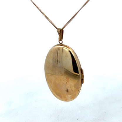 9ct yellow gold locket pendant with engraved details, weight 6.6g, from Reeves and Sons, shown with intricate design and polished finish.