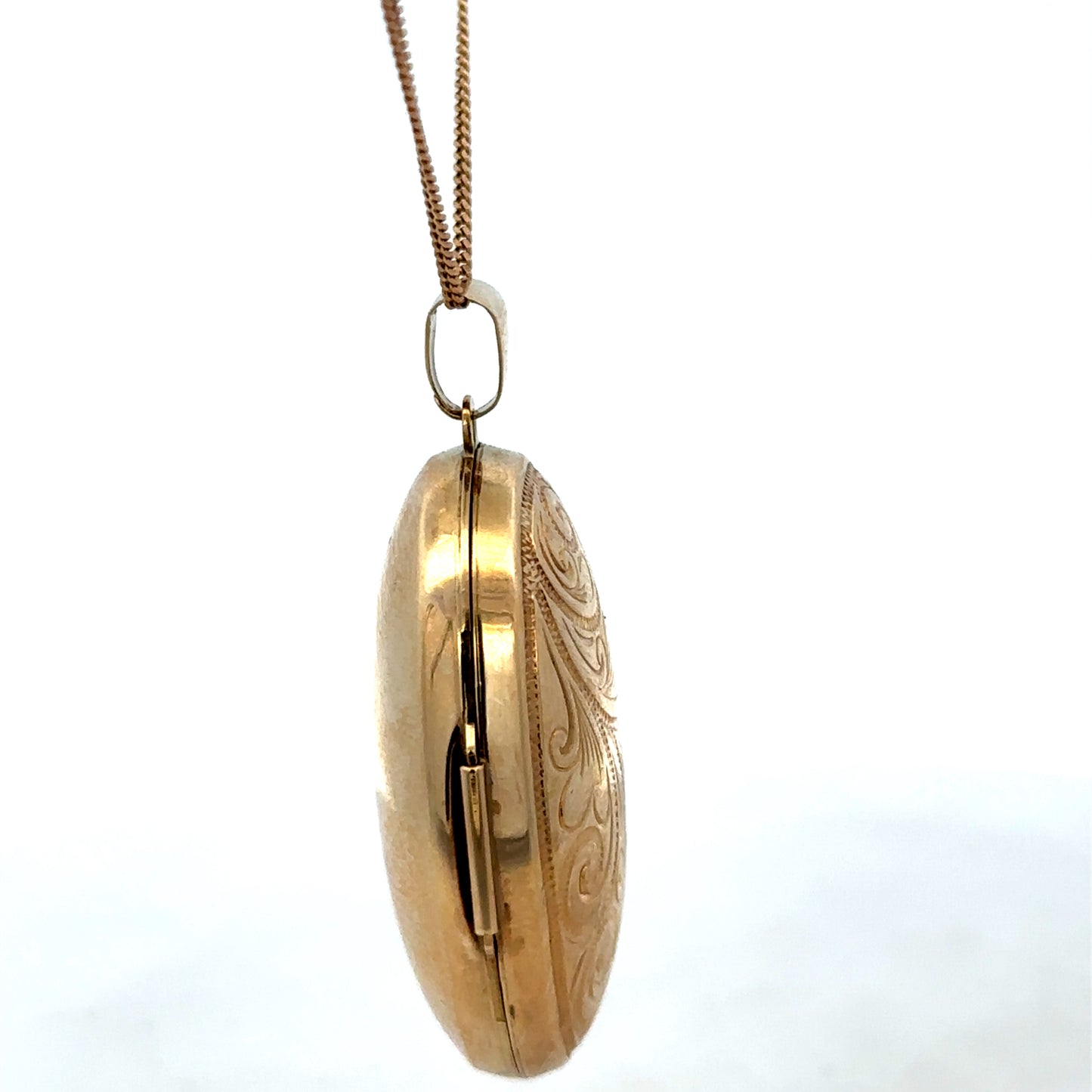 9ct yellow gold locket pendant with a polished finish, weighing 6.3g, by Reeves and Sons, shown in a close-up image.