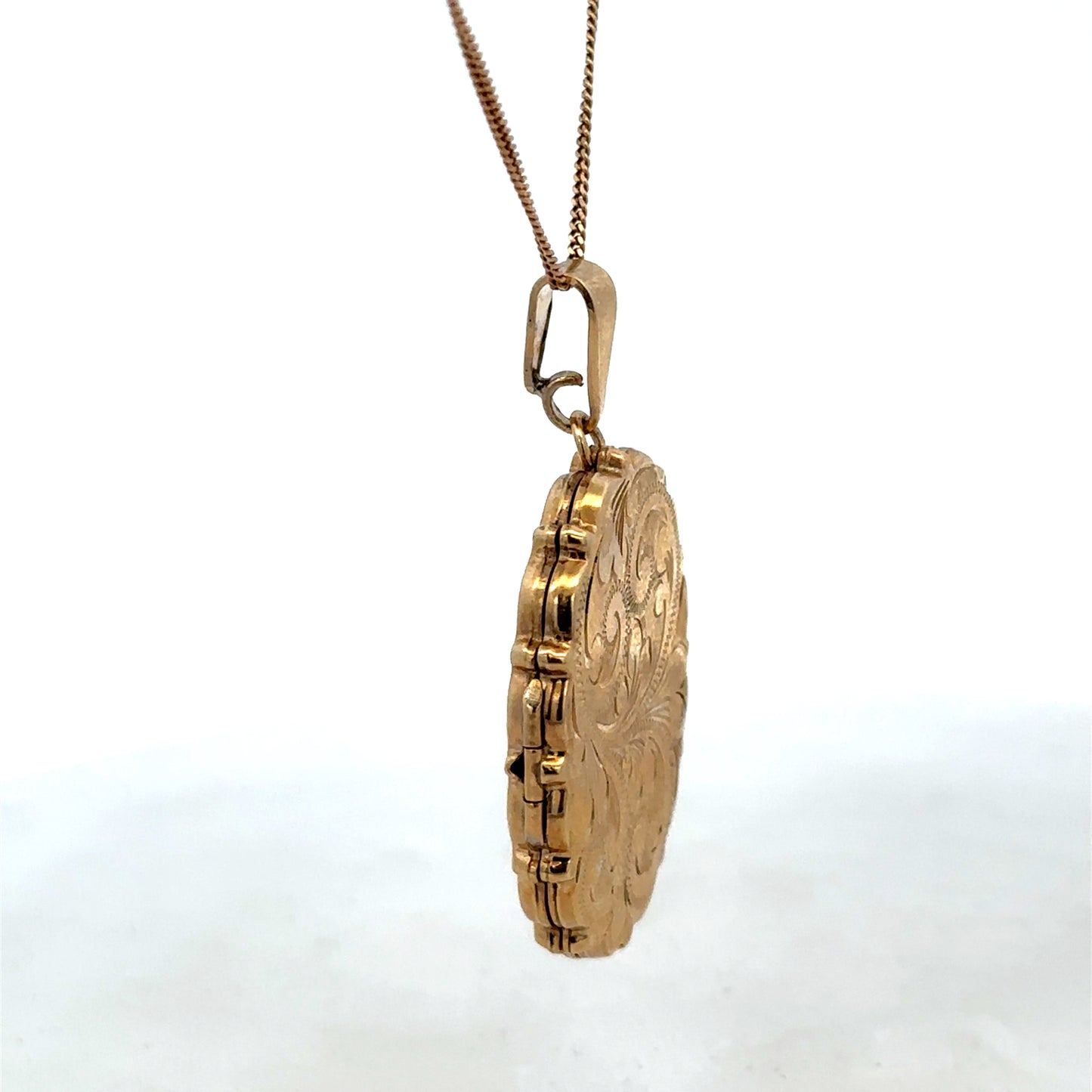 9ct yellow gold locket pendant with intricate design, weighing 8.1g, crafted by Reeves and Sons.