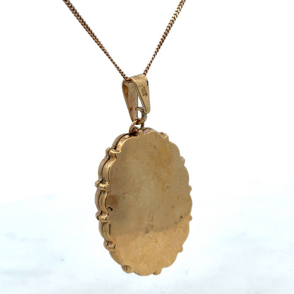 9ct yellow gold locket pendant by Reeves and Sons, showcasing a polished, oval-shaped jewelry piece with intricate detailing.