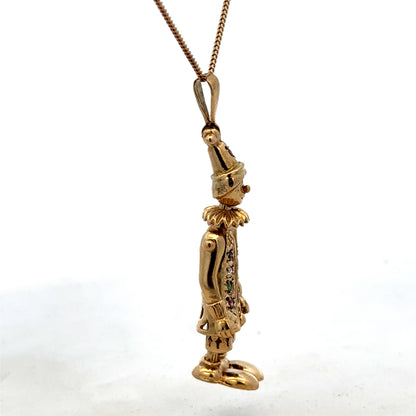 9ct yellow gold clown pendant by Reeves and Sons, detailed design, weighs 8.7g, shown against a plain background.