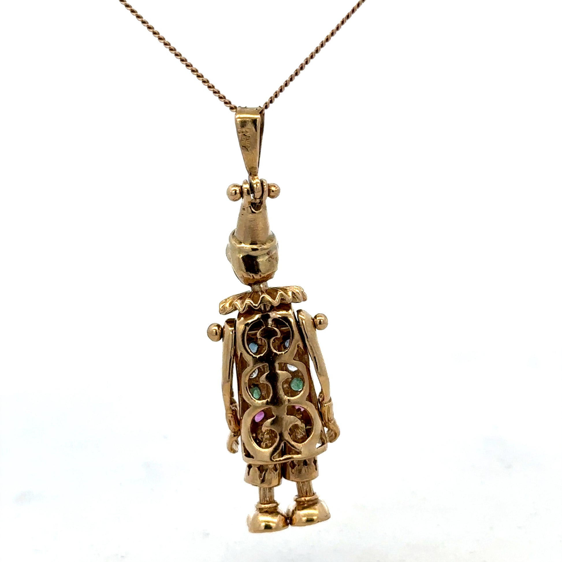 Yellow gold clown pendant from Reeves and Sons, 9ct gold, detailed design, weighing 8.7g, featuring playful clown motif.