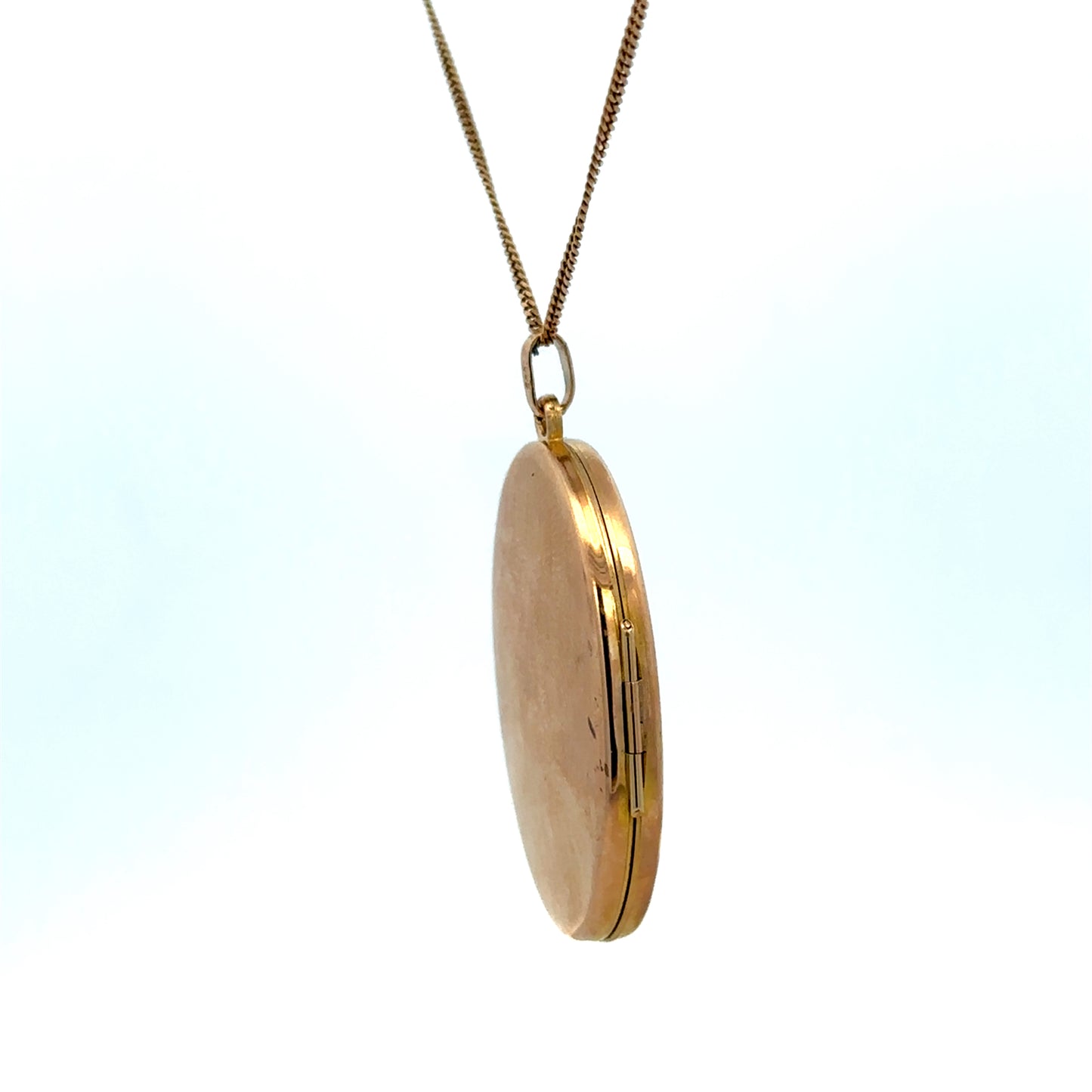 Reeves and Sons 9ct yellow gold locket pendant with intricate design, weighing 6.7g, displayed against a neutral background.
