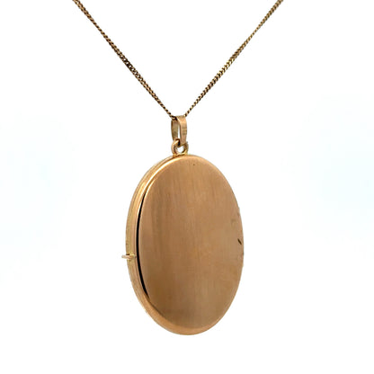 9ct yellow gold locket pendant by Reeves and Sons, weighing 6.7g, featuring a classic design with intricate detailing.