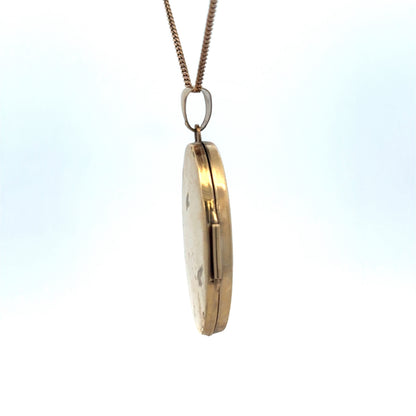 Reeves and Sons 9ct yellow gold locket pendant, 4.2g, featuring a classic oval design with intricate detailing.