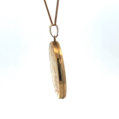 Reeves and Sons 9ct yellow gold locket pendant with floral engraved design, weighs 4.2g, shown on a jewelry display stand.