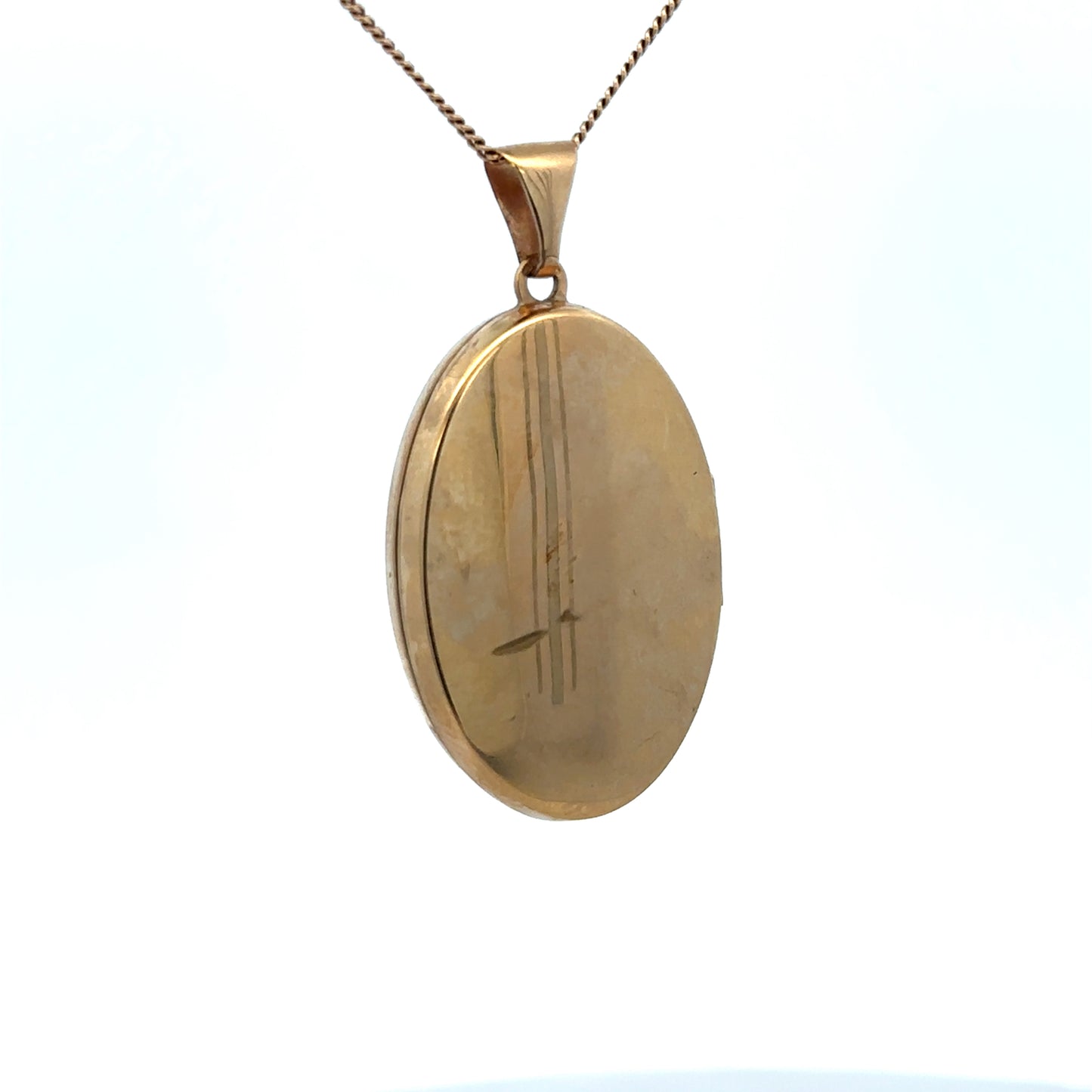 9ct yellow gold locket pendant by Reeves and Sons, featuring intricate design, weight 4.4g, in a close-up image.