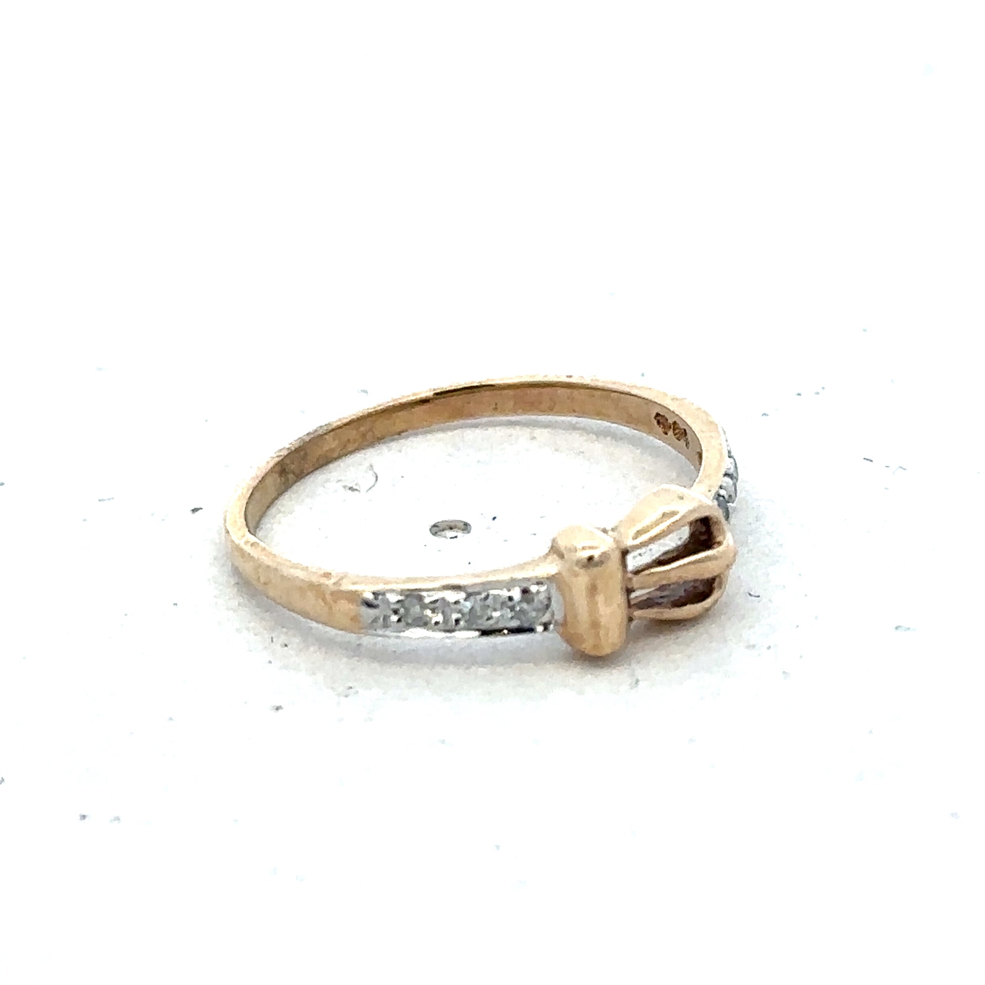 9ct yellow gold buckle ring size M 1/2 by Reeves and Sons, featuring a polished gold buckle design on a smooth band.