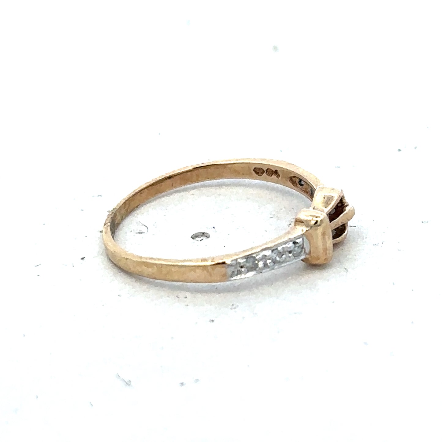9ct yellow gold buckle ring in size M 1/2 by Reeves and Sons, detailed close-up showing polished gold finish and buckle design.